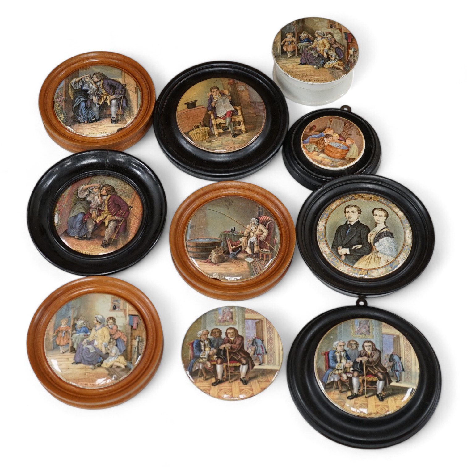 Nine 19th century framed pot lids including ‘Hide and Seek’ and ‘Uncle Toby’ and a jar and cover, largest overall 16cm diameter. Condition - fair to good